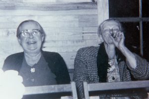 Mary W. Toler smoking cigar as Celia Toler laughs